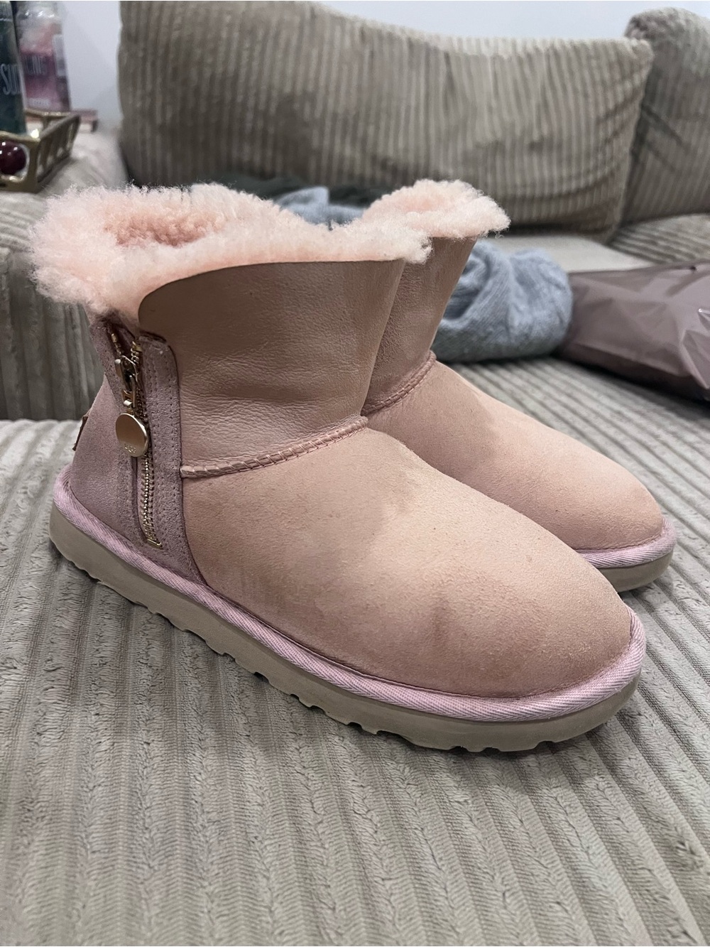 light pink UGG Bailey Zip Mini boots featuring a side zipper